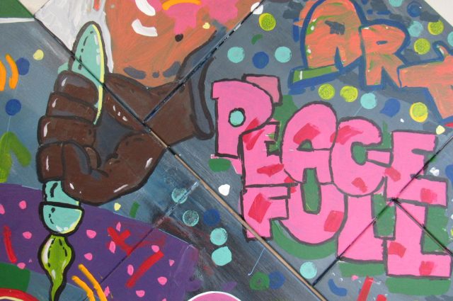 graffiti art with paintbrush in a hand and the words peace full and Art
