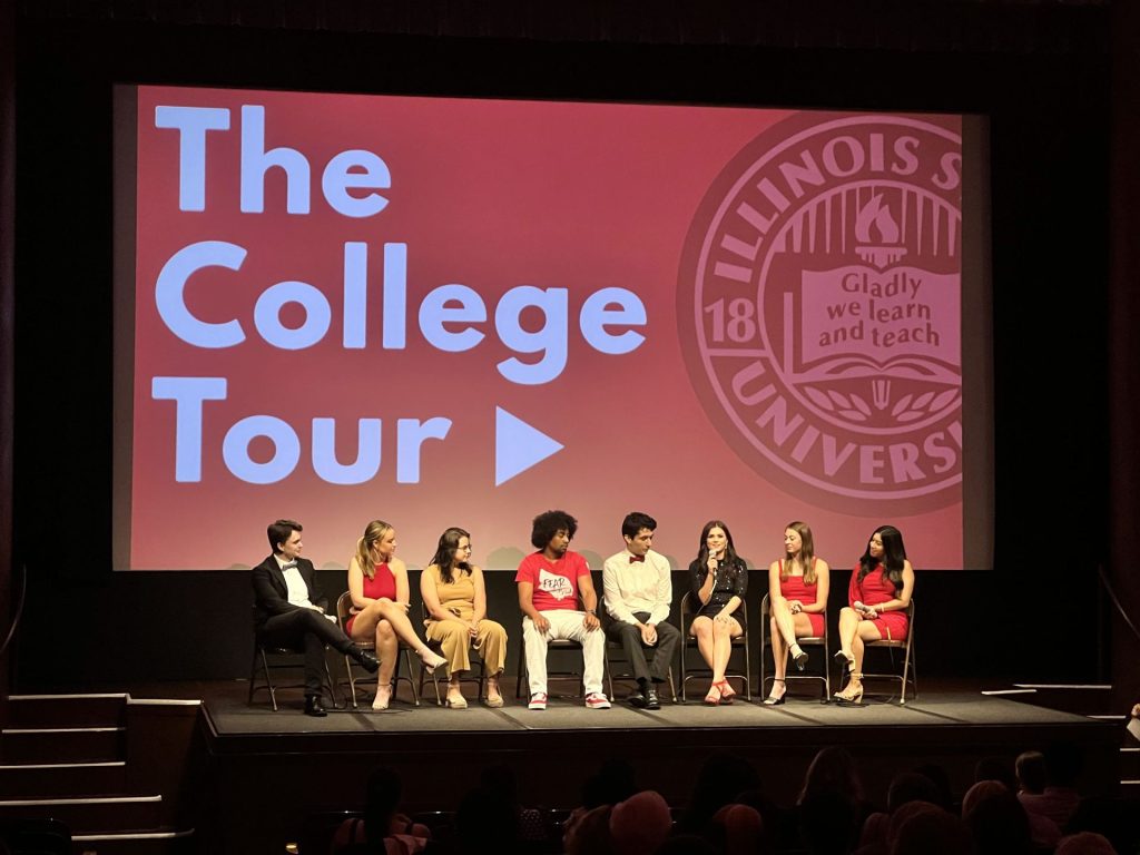 A group of students sitting down on stage.
