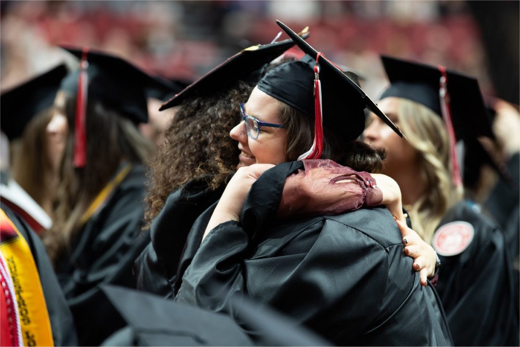 Image showing two students embracing at graduation