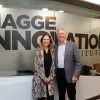 Sharon and Stephen Hagge standing together in front of glass with "Hagge Innovation Institute" written on glass behind them