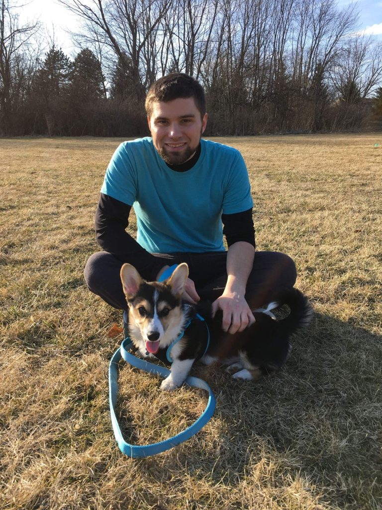Logan is pictured with his corgi Finn.