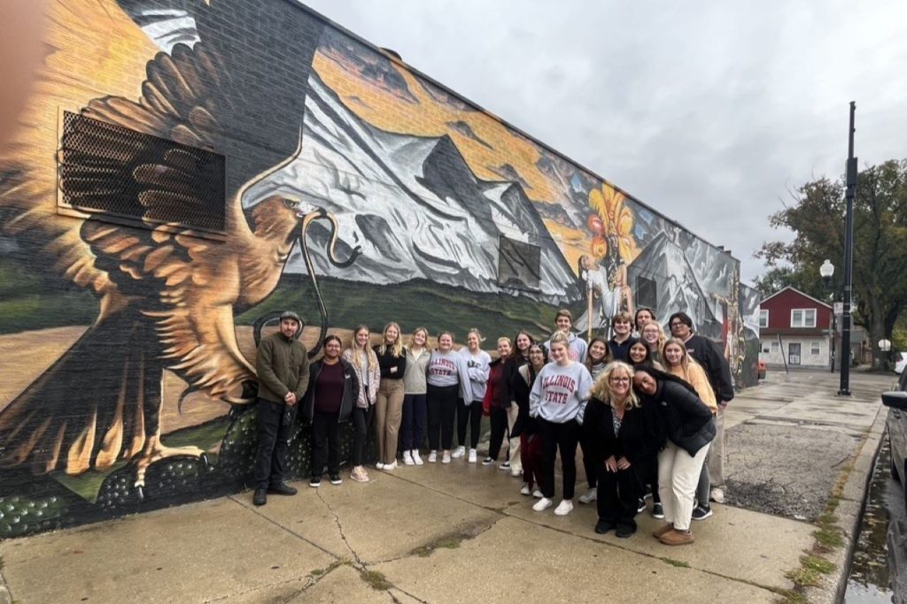 Students by a mural in Pilsen
