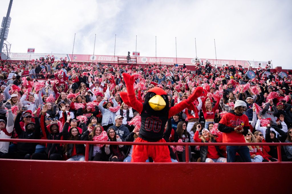 Reggie Redbird with ISU fans on the stands at a football game.
