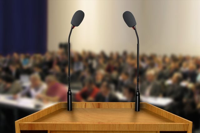 empty podium in front of a crowd of people for a presentation