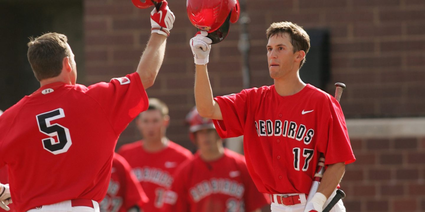 Two Redbird baseball players about to knock helmets in a celebration on cover of summer 2010 Illinois State magazine cover
