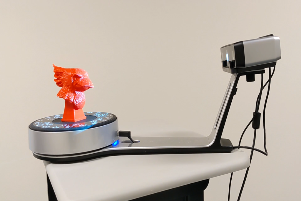 3D scanne in the process of scanning a 3D printed bust of Reggie Redbird.
