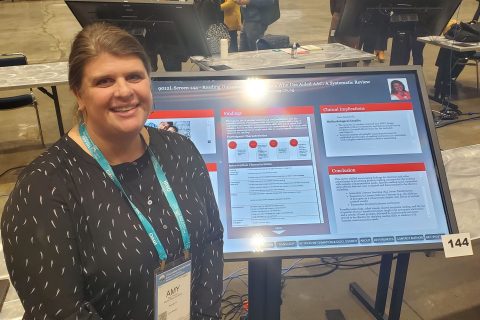 Amy Yacucci presenting an electronic poster at the ASHA Convention. 
