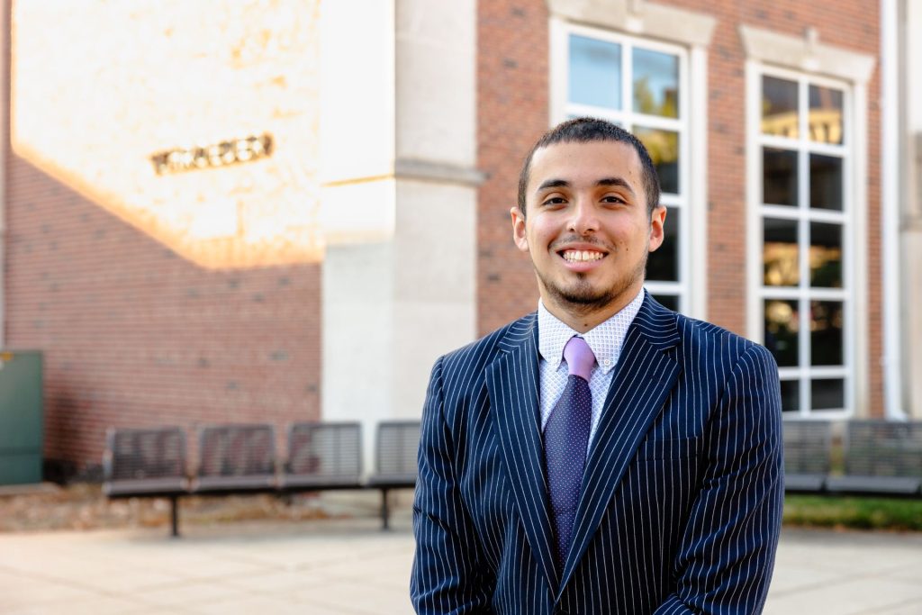 Christian Arceo standing in front of  Schroeder Hall