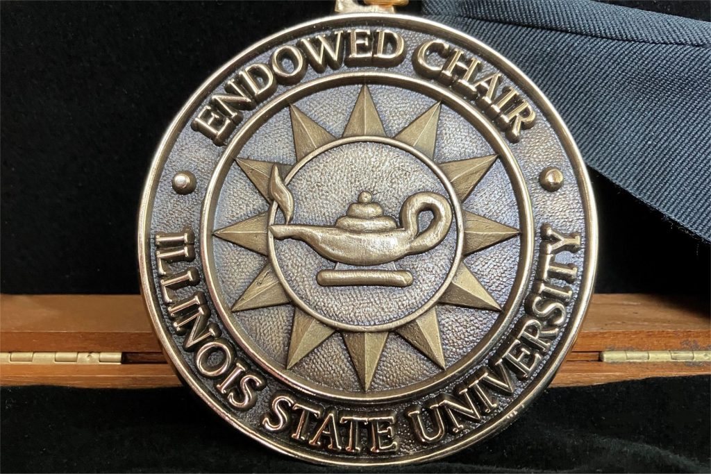 The bronze-cast medallion of the Cross Endowed Chair in the Scholarship of Teaching and Learning