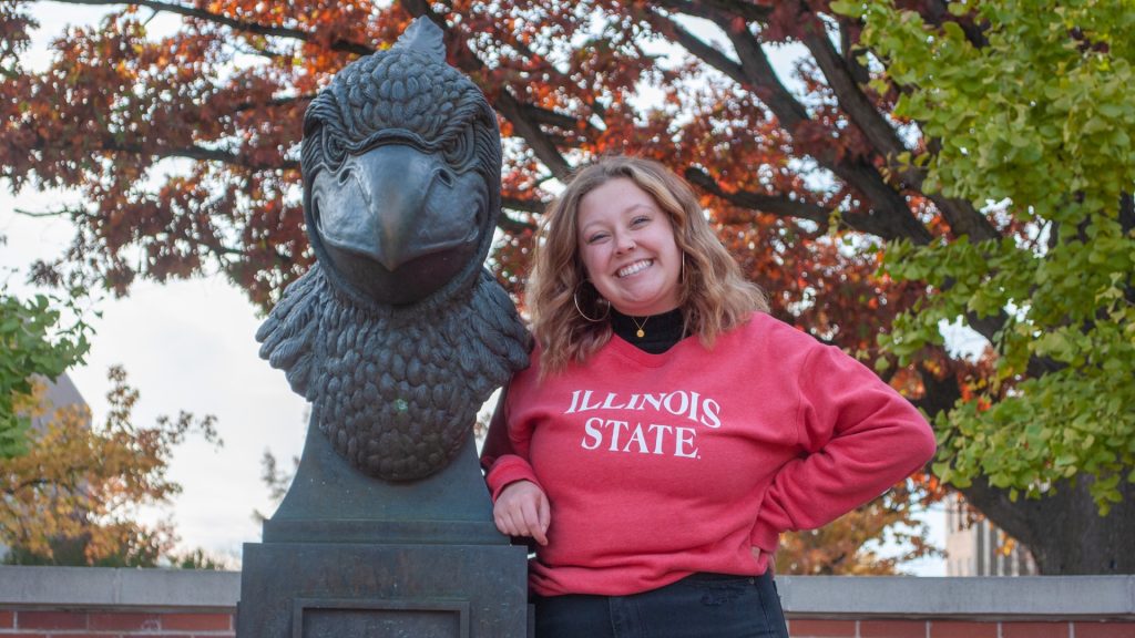 ISU student standing next to the Battle Bird