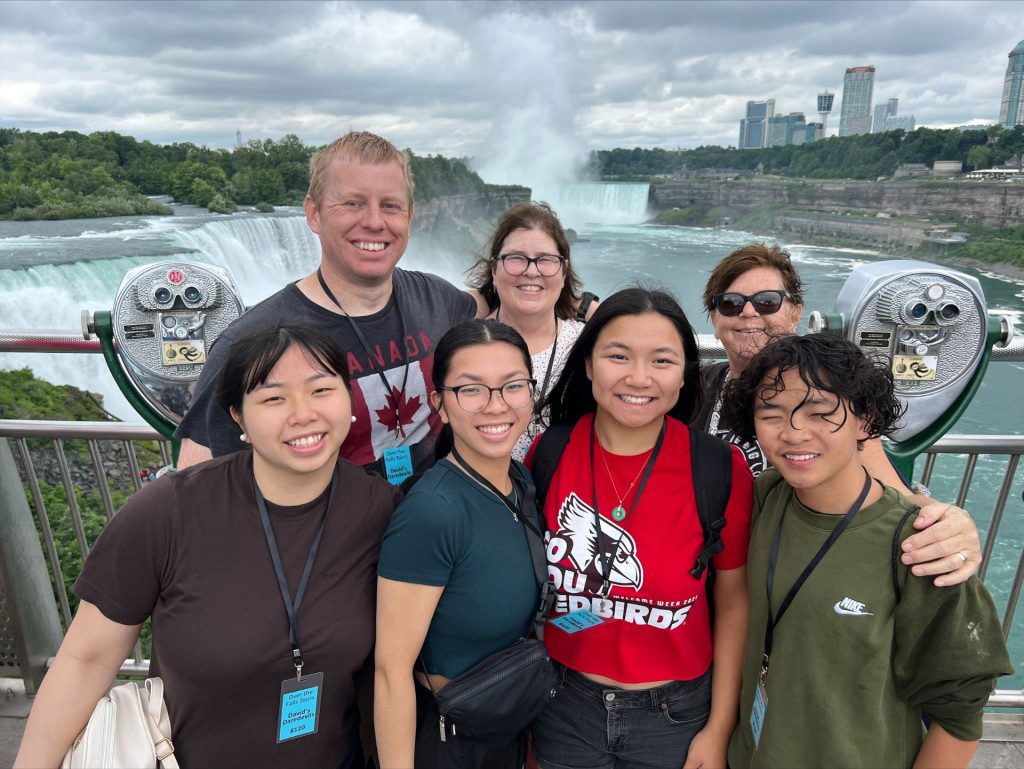 The families stand in front of Niagara Falls
