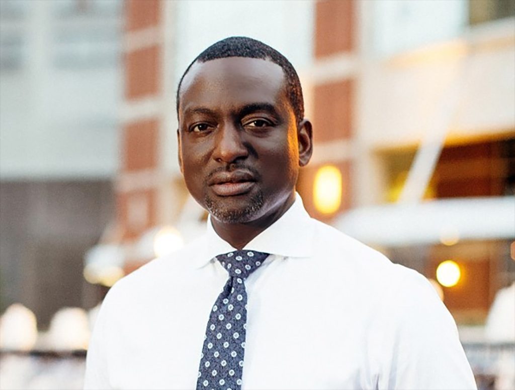 Dr. Yusef Salaam in front of a building
