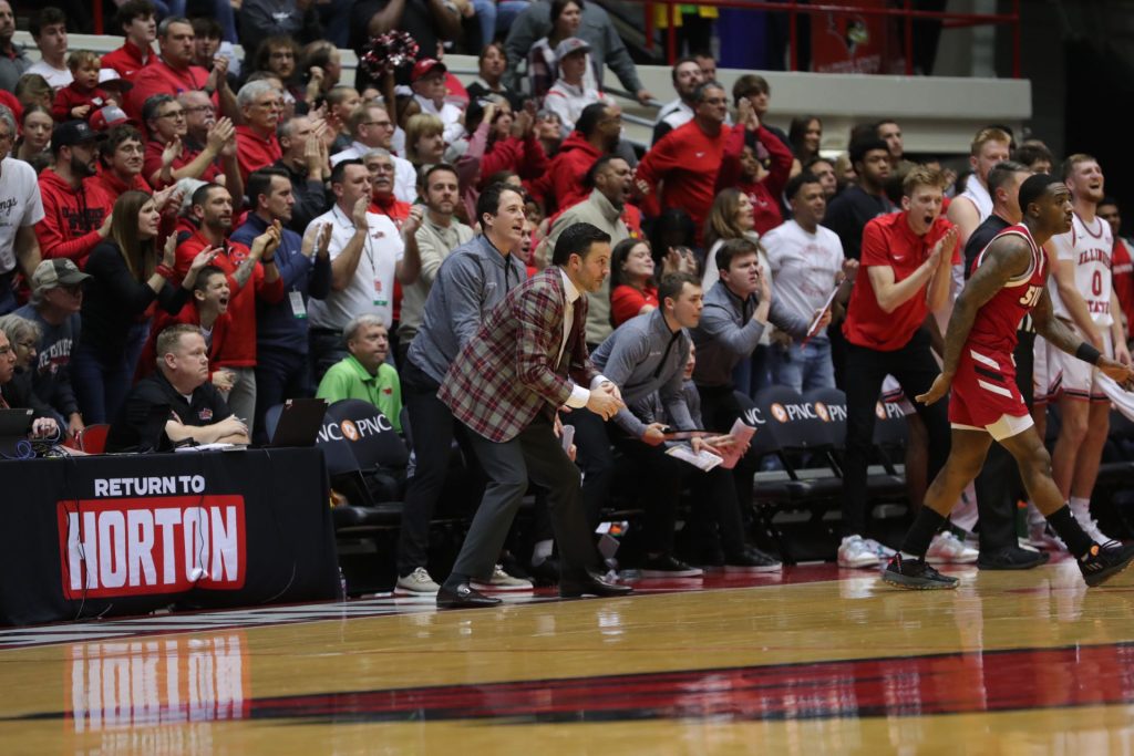 Ryan Pedon and the ISU bench celebrate with fans in the background