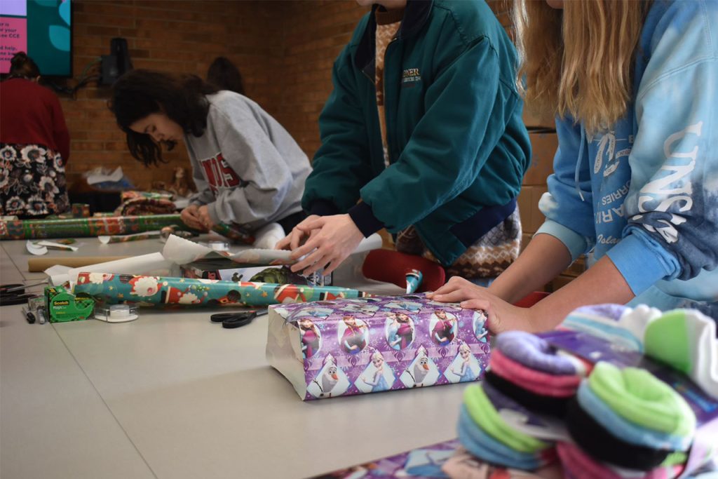 Volunteers wrapping gifts