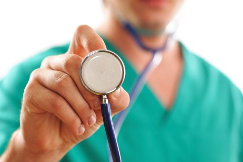 health care professional holding a stethoscope