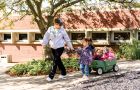 A worker pulls a wagon of children at the Child Care Center