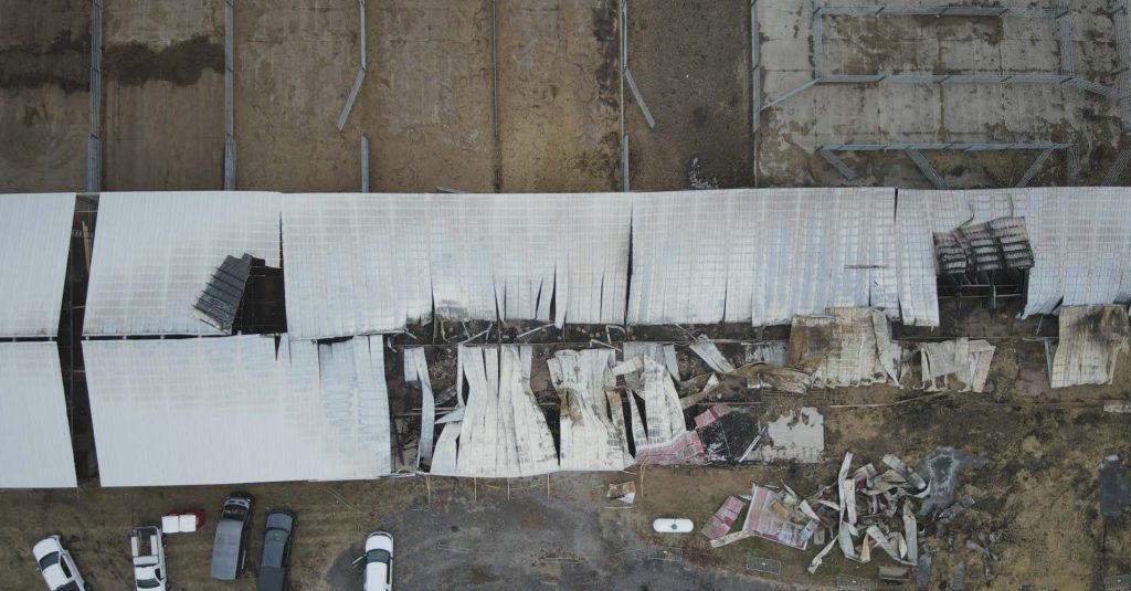 an aerial photo shows fire damage to the cow barn at University Farm