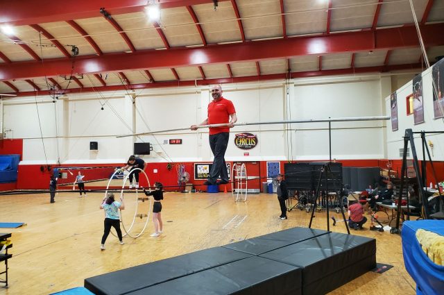 Marcus Alouan, Executive Director of Gamma Phi Circus, on the tightwire in Horton South Gym.