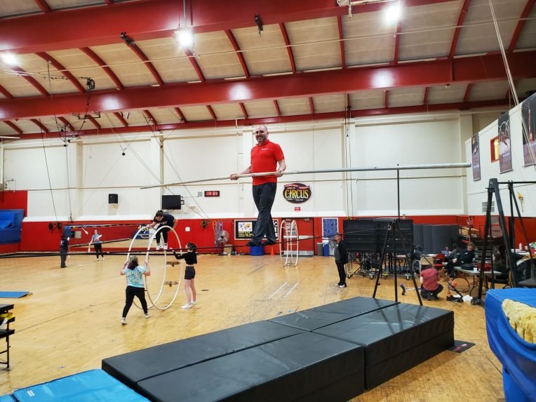 Marcus Alouan, Executive Director of Gamma Phi Circus, on the tightwire in Horton South Gym.