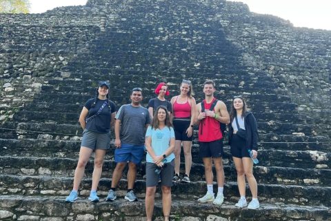 Group of people standing on Mayan ruins steps