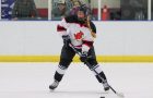 An ISU women's hockey player shoots the puck