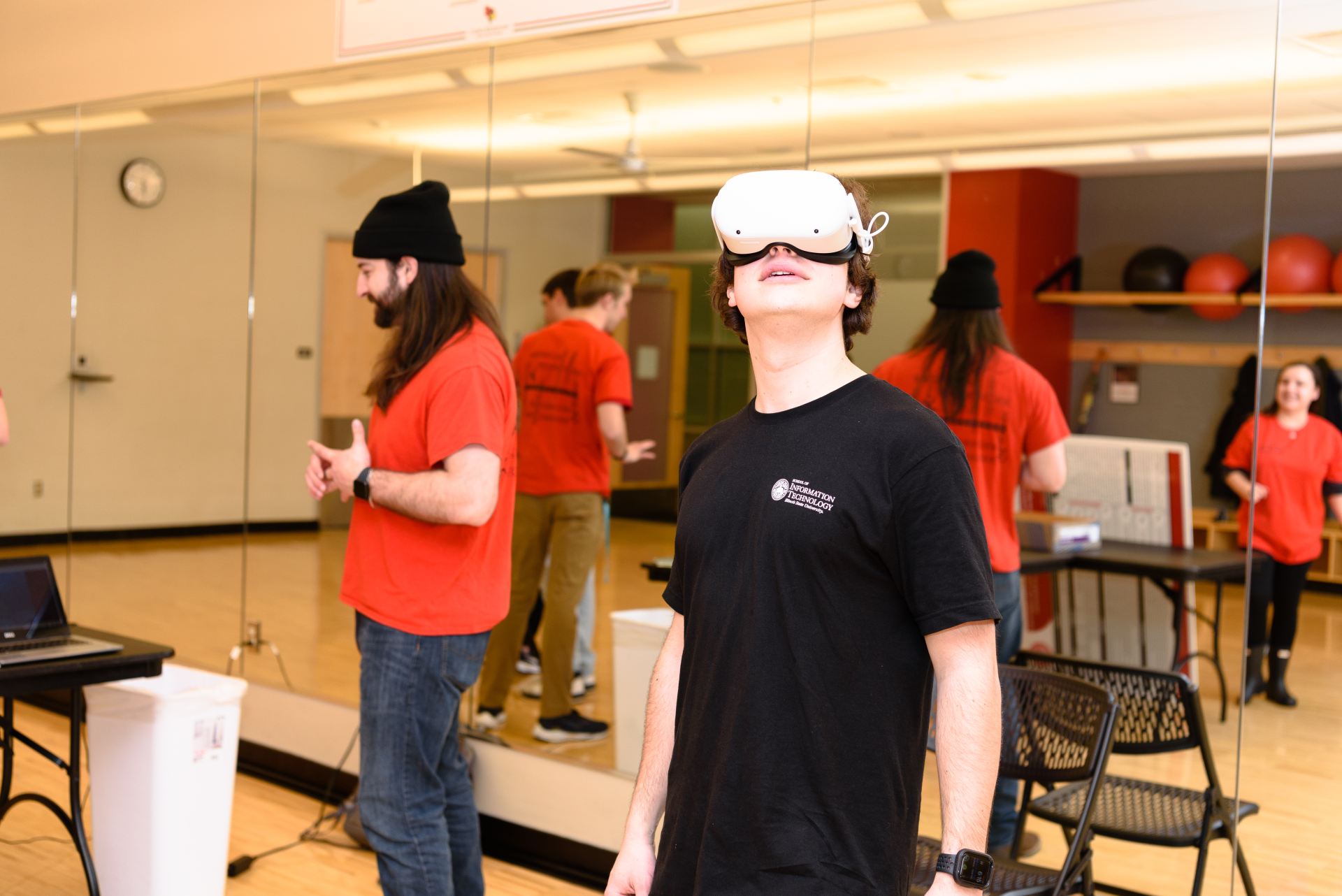 A student with a virtual reality headset on looks up