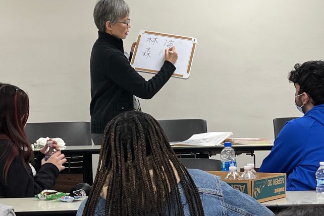 Mandarin Chinese instructor shows students words in Chinese.