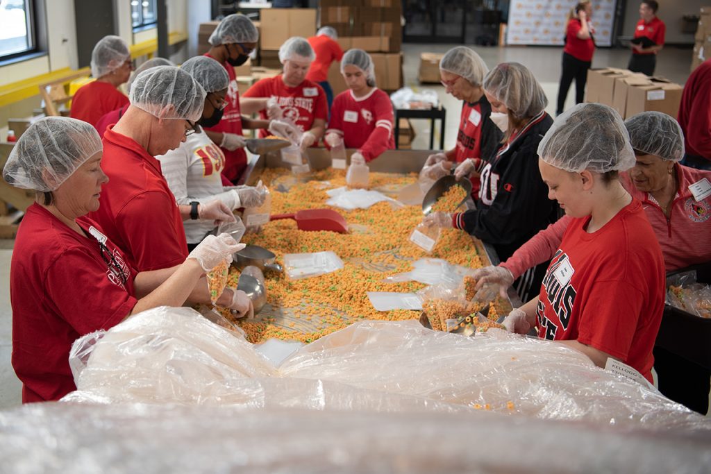 group of people bagging cereal at food bank