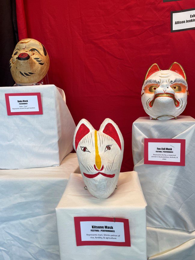 Three Japanese performative masks sitting on pedestals