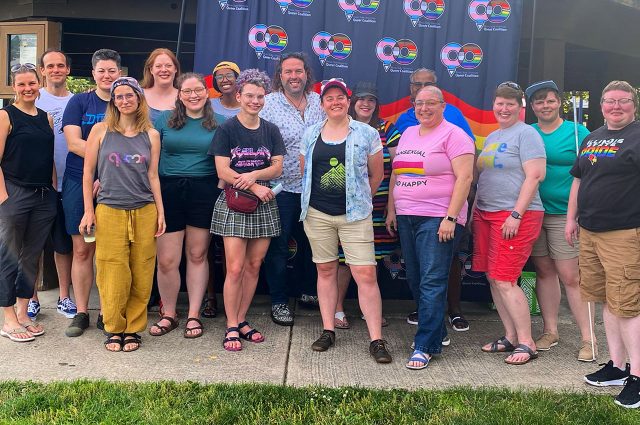 Queer Coalition members and their loved ones pose for a group photo in front of the gazebo in Anderson Park in June 2022.