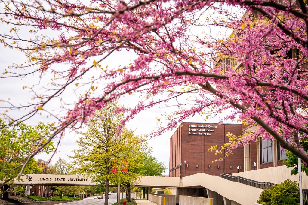 View of Bone Student Center and the overpass from College Avenue during spring with flowers in bloom.