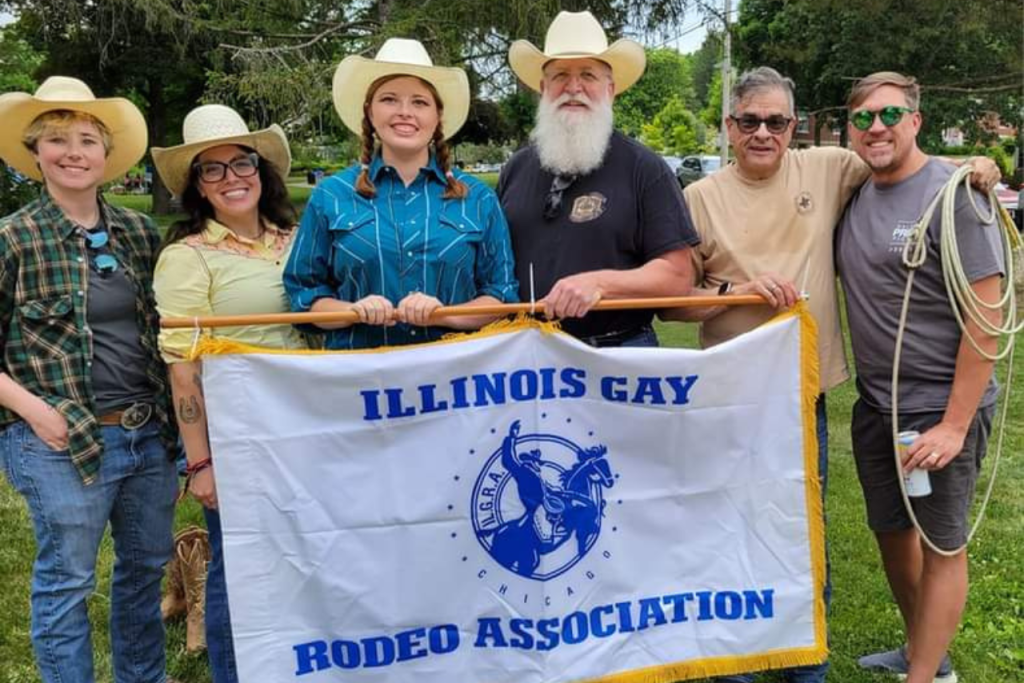 four people in cowboy hats holding banner