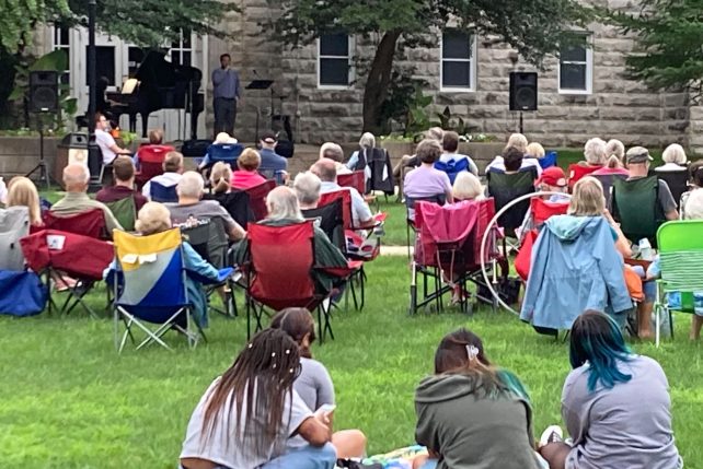 Image of previous Concert on the Quad season with people sitting in lawn chairs watching the concert!