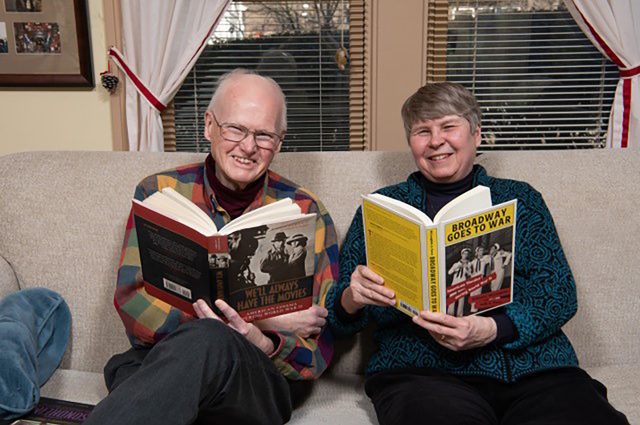 Dr. Robert McLaughlin and Dr. Sally Parry sit next to each other holding books