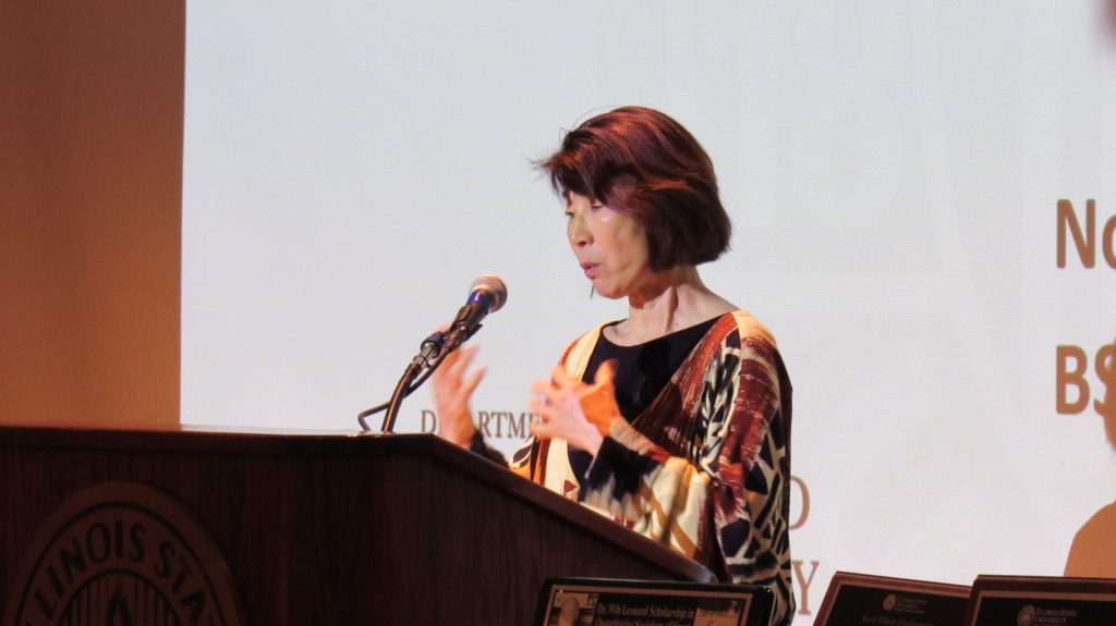 A woman speaking at a podium 