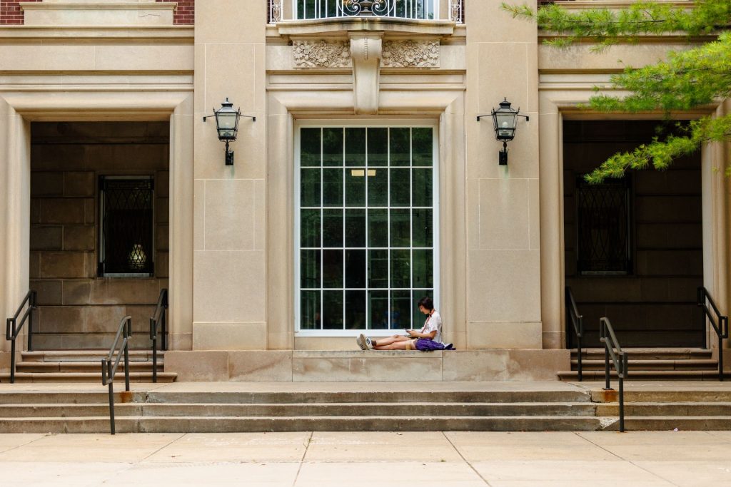 A student studies near Williams Hall on campus.