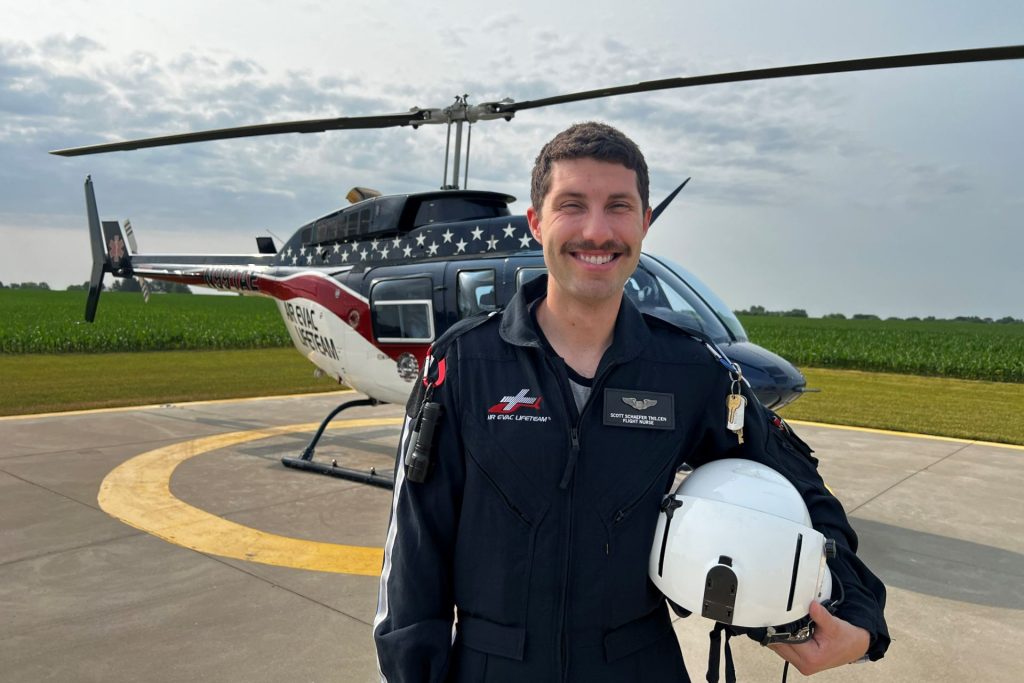 Scott Schaefer standing next to his air evac helicopter.