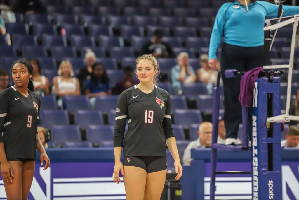 ISU volleyball players on the court look back toward bench