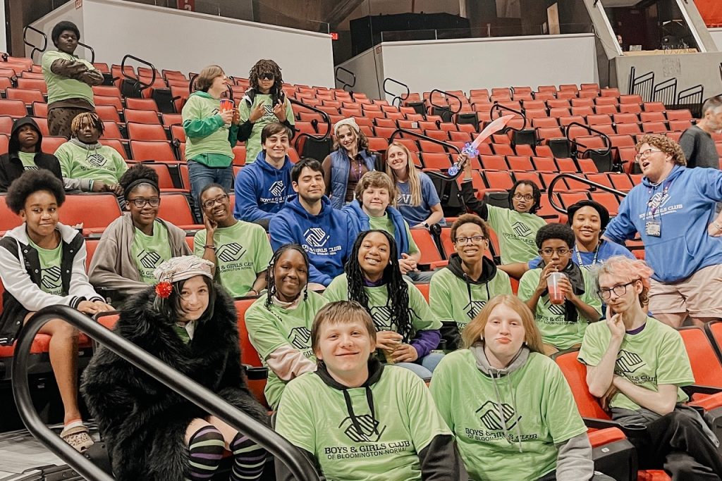 Local students and BGCBN Volunteers smile for a photo at Redbird Arena