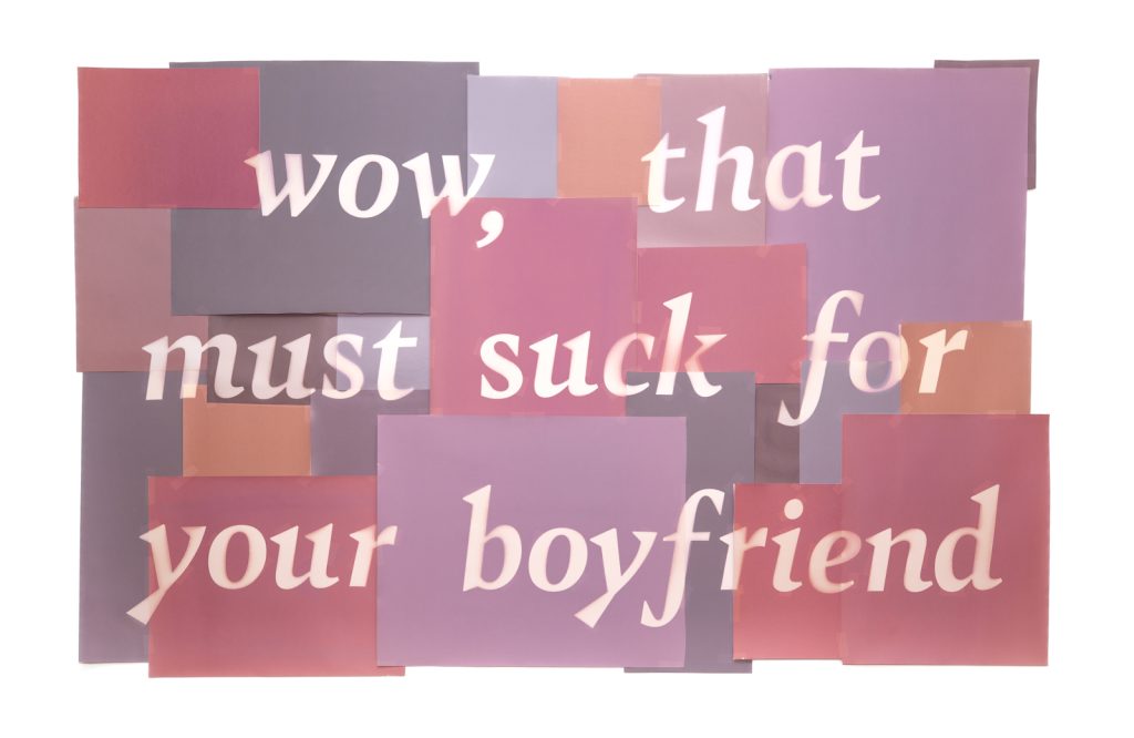 A collage of pink, purple, and peach colored paper that reads "Wow, that must suck for your boyfriend" in white lettering.