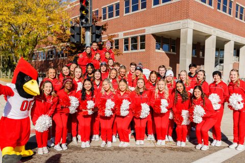 group of cheerleaders and reggie redbird mascot