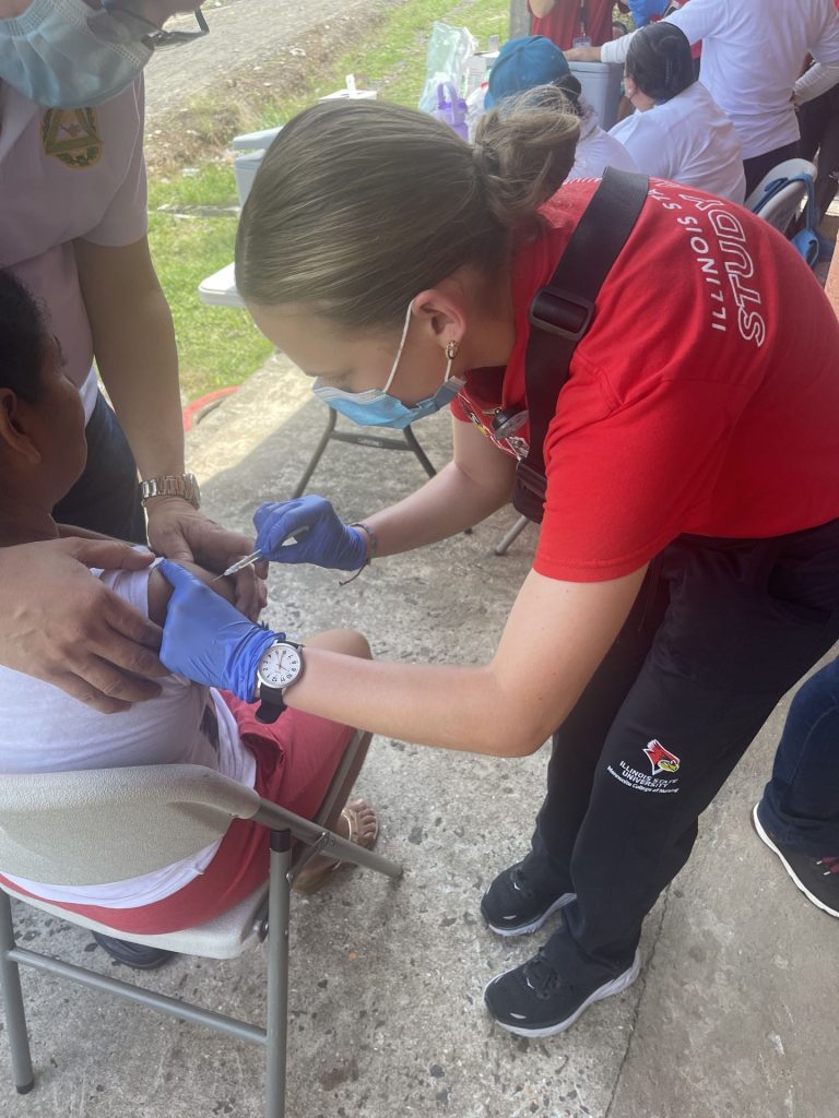 Rachel Patterson in Panama administrating a vaccine to a Panamanian child.