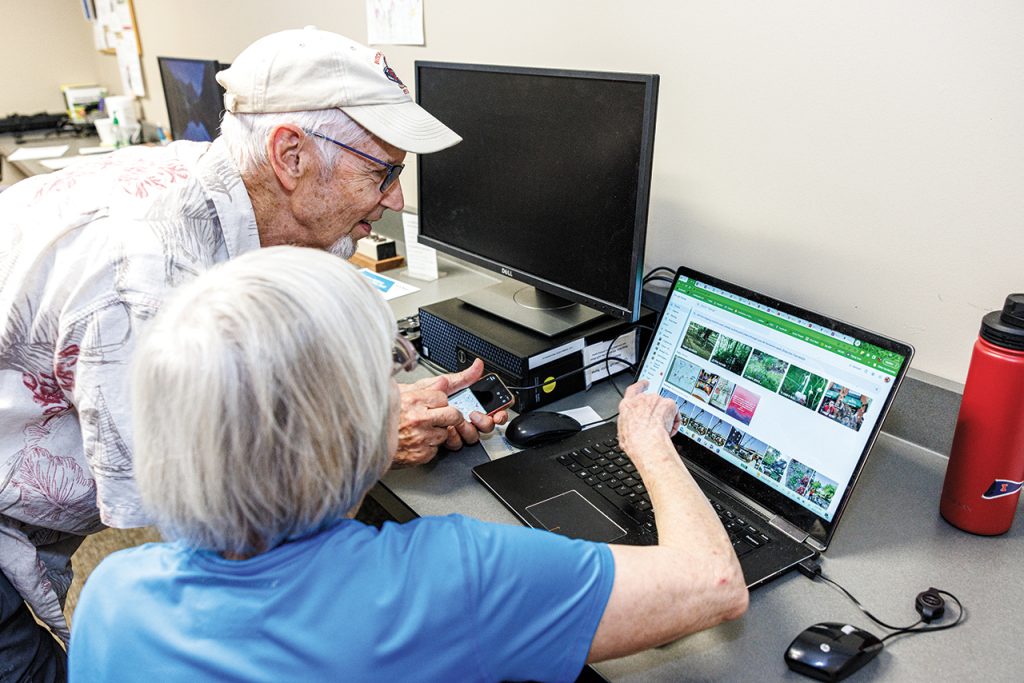 Participants in Oasis Connections Technology Education classes learn a variety of skills, including how to upload digital photos to a computer.