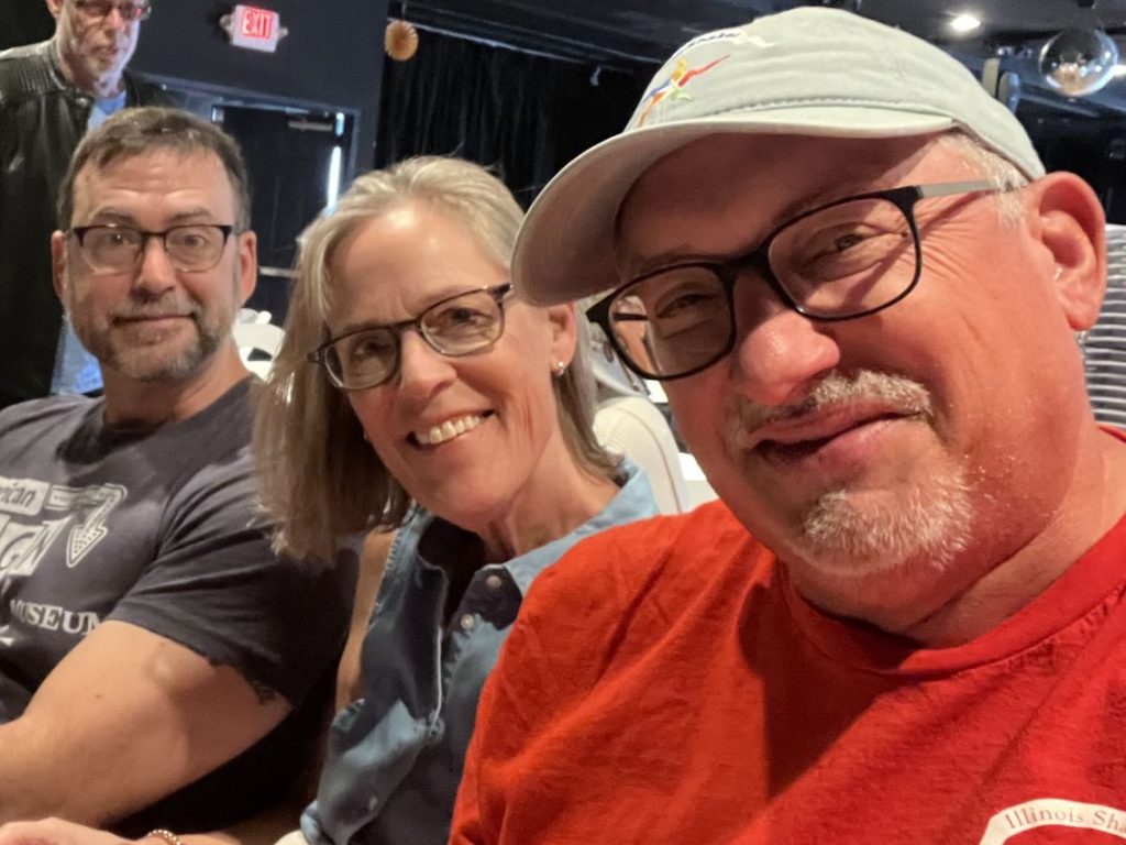 A selfie of Robert Quinlan, Lori Adams, and John Stark in casual clothing.
