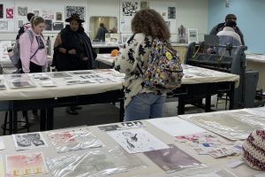 People browsing the hundreds of original art prints for sale during the Annual Printmakers' Exhibition and Sale.