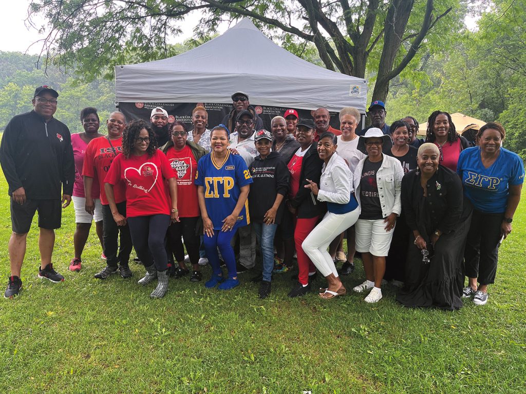 Black alumni group posed for group picture at a cookout