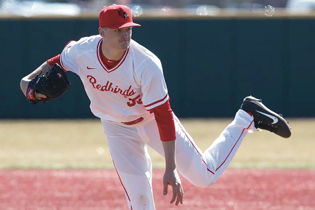 A Redbird baseball player delivers a pitch
