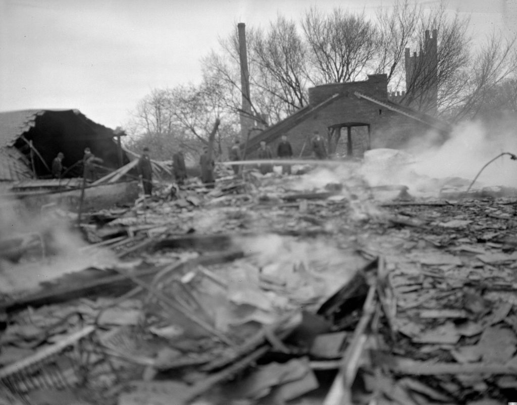 A black and white photo of smoldering rubble
