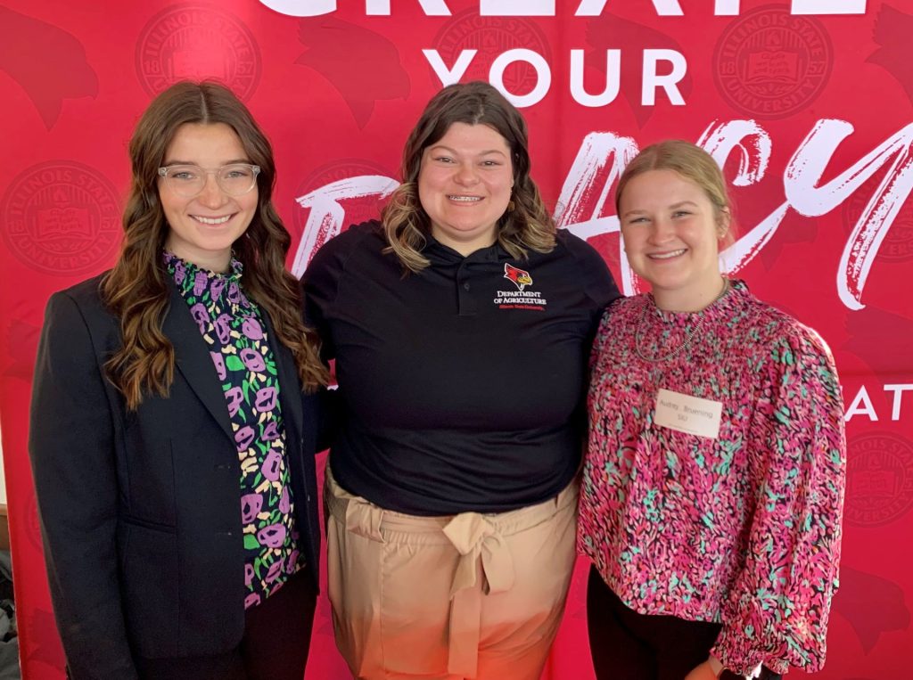 Southern Illinois University students Haley Bode and Audrey Bruening stand with ISU Agriculture Ambassador Beth Clark.