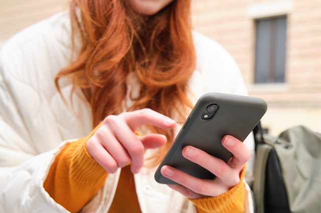 Student holding a smartphone